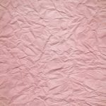 ピンク色のしわくちゃの紙のA4サイズ背景素材